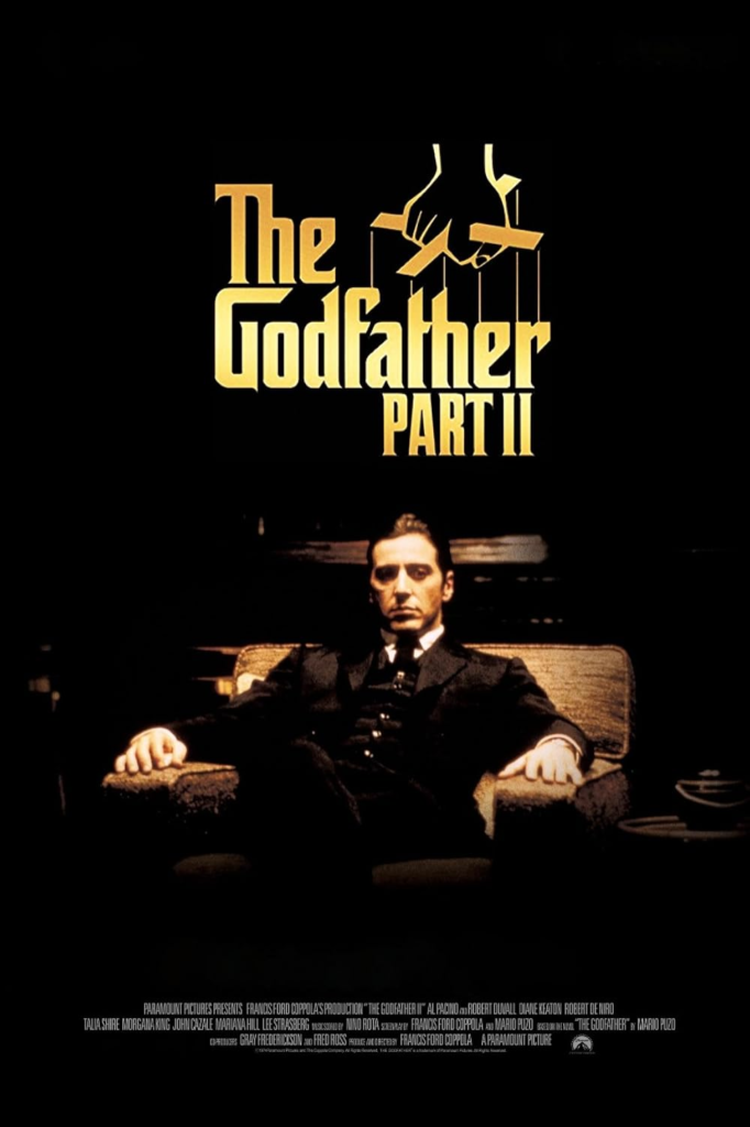 poster for the Godfather Part II with Al Pacino sitting in a arm chair and suit