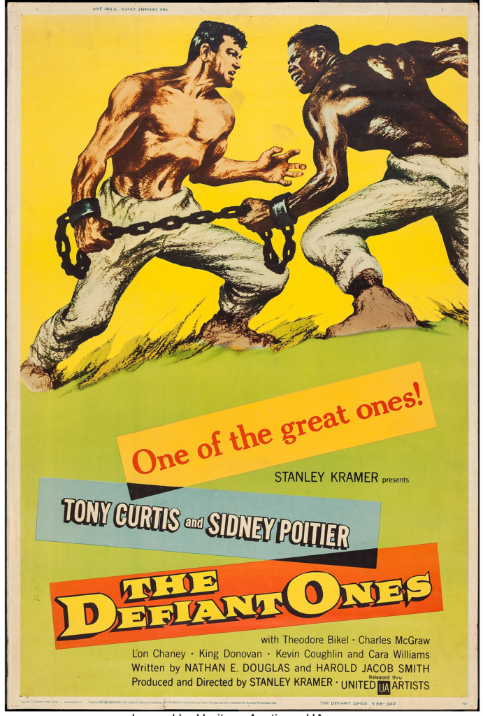 Poster for The Defiant Ones (1958) with two illustrated men fighting and attached at the wrists by a chain